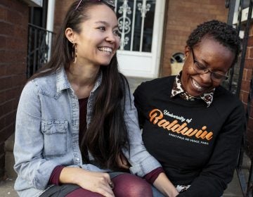 Rachelle Faroul, right, and her partner, Hanako Franz, sit outside their new home in Philadelphia