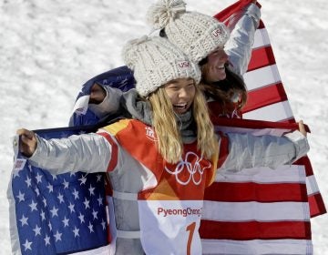 Gold medal winner Chloe Kim, of the United States, (1) and bronze winner Arielle Gold, of the United States, celebrate after the women's halfpipe finals at Phoenix Snow Park at the 2018 Winter Olympics in Pyeongchang, South Korea, Tuesday, Feb. 13, 2018. (AP Photo/Kin Cheung)