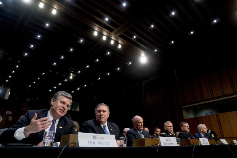 (From left) FBI Director Christopher Wray, accompanied by CIA Director Mike Pompeo, Director of National Intelligence Dan Coats, Defense Intelligence Agency Director Robert Ashley, National Security Agency Director Adm. Michael Rogers, and National Geospatial-Intelligence Agency Director Robert Cardillo, speaks at a Senate Select Committee on Intelligence hearing on worldwide threats, Tuesday, Feb. 13, 2018, in Washington. (Andrew Harnik/AP Photo)