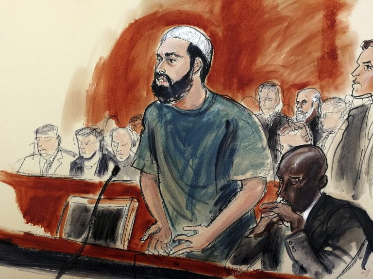 In this courtroom drawing, defendant Ahmad Khan Rahimi reads a statement to the judge during his sentencing hearing in New York, Tuesday, Feb. 13, 2018. Rahimi was sentenced to multiple terms of life in prison for setting off small bombs in two states, including a pressure cooker device that blasted shrapnel across a New York City block. At right is attorney Xavier Donaldson, Rahmin's attorney. (Elizabeth Williams via AP)