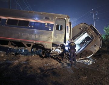 In this May 12, 2015, file photo, emergency personnel work the scene of a deadly train wreck in Philadelphia. An Amtrak train headed to New York City derailed and crashed in Philadelphia. (AP Photo/ Joseph Kaczmarek, File)