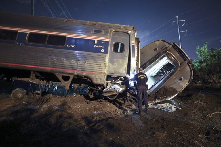 In this May 12, 2015, file photo, emergency personnel work the scene of a deadly train wreck in Philadelphia. An Amtrak train headed to New York City derailed and crashed in Philadelphia. (AP Photo/ Joseph Kaczmarek, File)