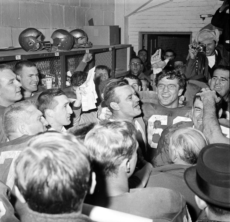 Norm Van Brocklin, left, who quarterbacked the Philadelphia Eagles to a 17-13 win over the Green Bay Packers in 1960, alternately laughs and cries in dressing room at Franklin Field. With him is Chuck Bednarik. (AP photo)