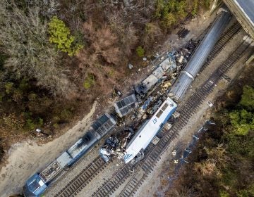An aerial view of the site of an early morning train crash Sunday, Feb. 4, 2018 between an Amtrak train, bottom right, and a CSX freight train, top left, in Cayce, SC. The Amtrak passenger train slammed into a freight train in the early morning darkness Sunday, killing at least two Amtrak crew members and injuring more than 110 people, authorities said.  (Jeff Blake/AP Photo)
