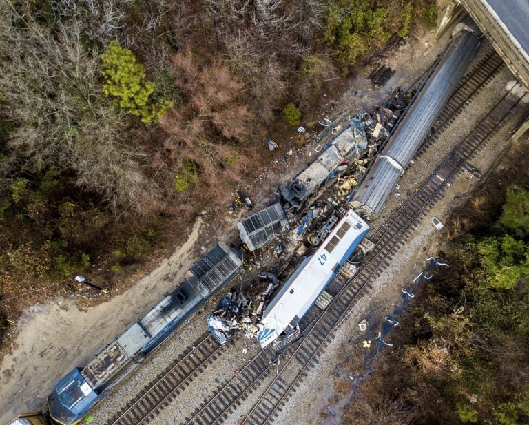 An aerial view of the site of an early morning train crash Sunday, Feb. 4, 2018 between an Amtrak train, bottom right, and a CSX freight train, top left, in Cayce, SC. The Amtrak passenger train slammed into a freight train in the early morning darkness Sunday, killing at least two Amtrak crew members and injuring more than 110 people, authorities said.  (Jeff Blake/AP Photo)