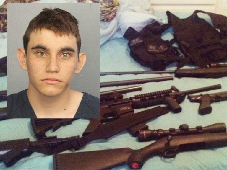 Nikolas Cruz pictured over a photo posted on his Instagram account which shows weapons lying on a bed. Cruz was charged with 17 counts of premeditated murder on Thursday, Feb. 15, 2018, the day after opening fire with a semi-automatic weapon in the Marjory Stoneman Douglas High School in Parkland, Fla. (Broward County Jail and Instagram via AP)