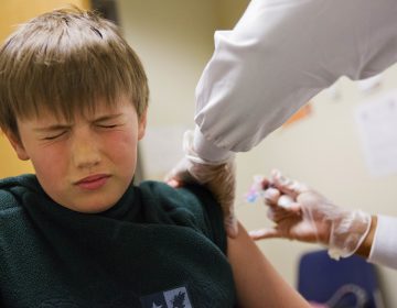 Reed Olson, 8, gets a flu shot, Monday, Feb. 5, 2018. The U.S. government's latest flu report released on Friday, Feb. 2, 2018, showed flu season continued to intensify the previous week, with high volumes of flu-related patient traffic in 42 states, up from 39 the week before. (David Goldman/AP Photo)
