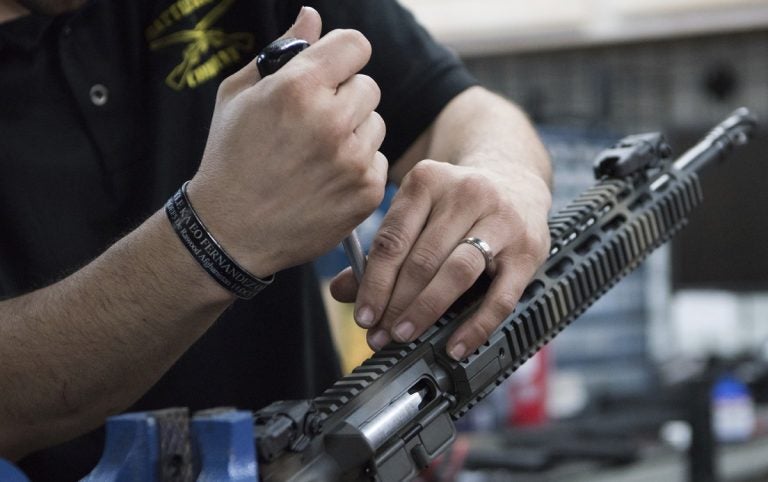 In this photo taken March 15, 2017, Karl Sorken, production manager for Battle Rifle Co., based in Webster, Texas, works on the rails of an AR-15style rifle. Battle Rifle is one of now more than 10,000 gunmakers in the United States. (Lisa Marie Pane/AP Photo)