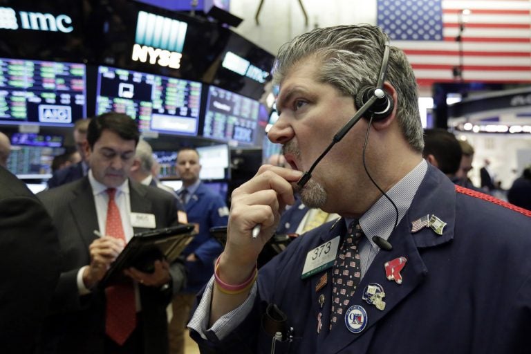 Trader John Panin, (right), works on the floor of the New York Stock Exchange, Friday, Feb. 9, 2018. Stocks struggled to stabilize Friday as investors sent prices climbing, then slumping in unsteady trading a day after the market entered its first correction in two years. (Richard Drew/AP Photo)