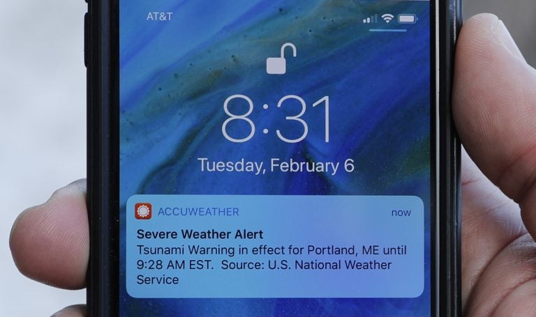 In this Thursday, Feb. 8, 2018 photo Jeremy DaRos shows the erroneous tsunami alert he received on his phone on Tuesday, Feb. 6, 2018, in Portland, Maine. DeRos, who lives near the water, said he is concerned that people won't take seriously the emergency alerts they get in an actual crisis. (Robert F. Bukaty/AP Photo)