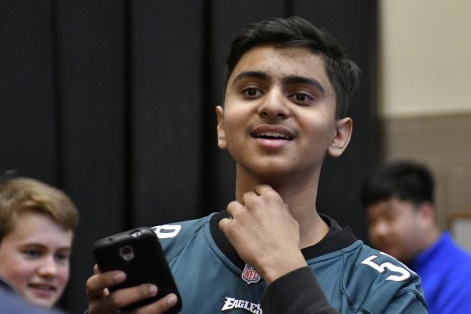 9th-grade percussionist Prem Modi looks on as Philadelphia Eagles center Jason Kelce arrives in the auditorium of Central High School, on Thursday. (Bastiaan Slabbers/for WHYY)