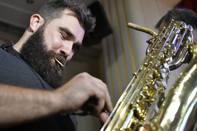 Philadelphia Eagles center, Cleveland Heights High School alumni, and former jazz band member Jason Kelce prepares the baritone sax he used to play, 12 years ago at his alma mater in Cleveland. (Bastiaan Slabbers/for WHYY)