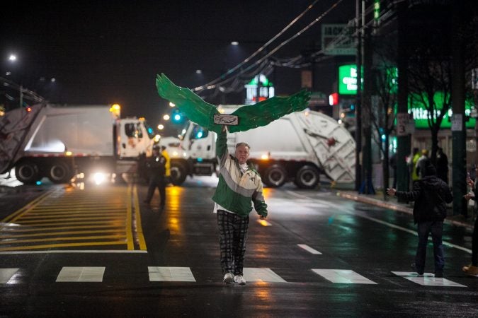 Eagles fans celebrate just before the end of regulation during Superbowl LII against the New England Patriots at Frankford and Cottman Avenue Sunday night. (Brad Larrison for WHYY)