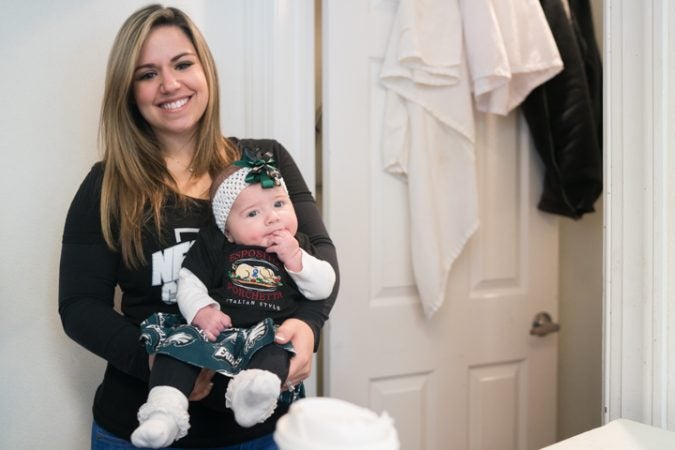 Jessica Esposito poses for a portrait with her three month old child at Esposito’s Porchetta in South Philadelphia before the Super Bowl on January 4, 2018. (Branden Eastwood for WHYY)