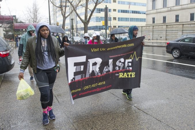 Marchers pass through the Spring Garden section of the city en route to the Philadelphia Medical Examiner's office. (Jonathan Wilson for WHYY)