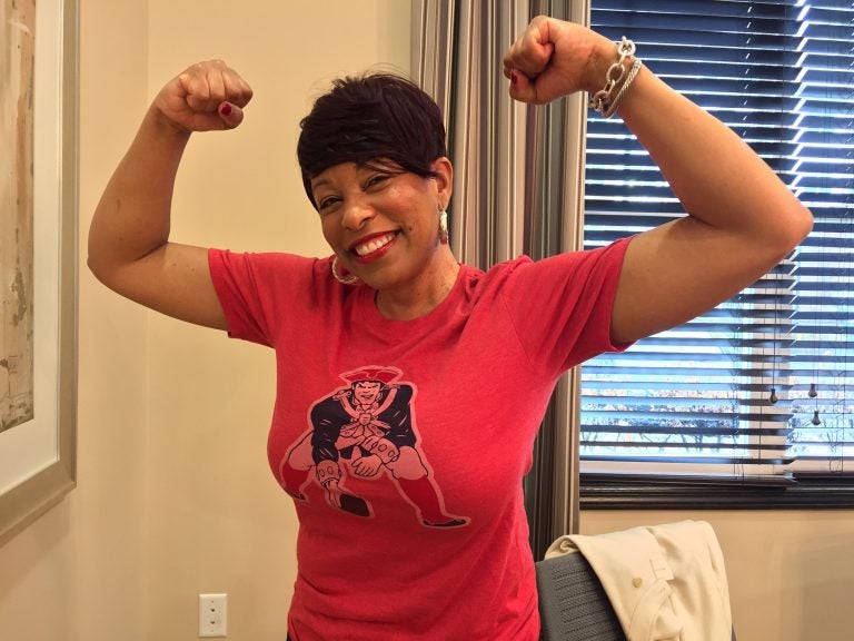 HYYJHpatriotsfan Cherry Hill resident Kimberly Reed, a Boston transplant, is rooting for the New England Patriots in this year’s Super Bowl. Many of her friends support the Eagles. (Joe Hernandez/WHYY)