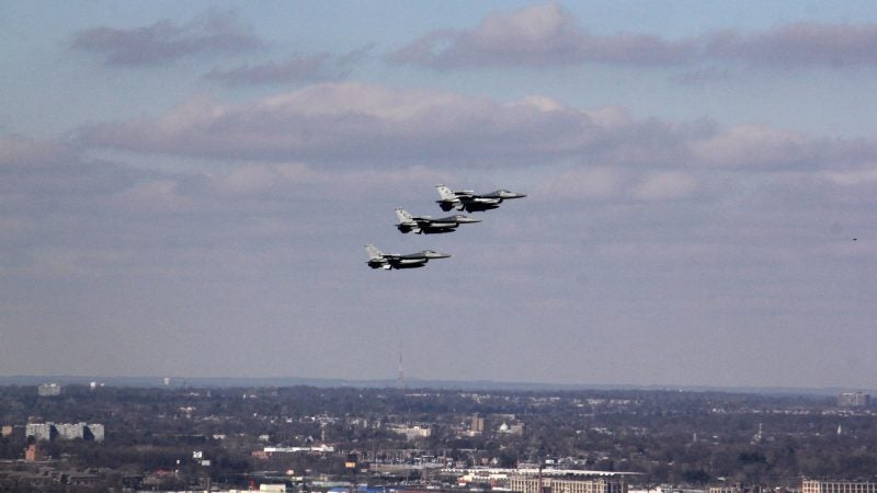 Three fighter jets soar above the Ben Franklin Parkway during the Eagles Super Bowl parade. (Emma Lee/WHYY)