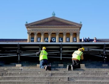 Workmen set up a stage in front of the Art Museum in preparation for the Eagles parade.