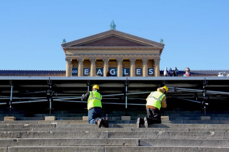 Workmen set up a stage in front of the Art Museum in preparation for the Eagles parade.