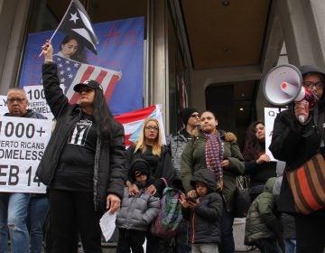 Activists call for more support for Puerto Ricans displaced by Hurricane Maria during a rally at Thomas Paine Plaza. They are joined by Carlos Torres (left), Muriel Rivera and her son, Yeriel, 6, (center left), and Melanie Garcia and her three children (center right), who all face eviction.
