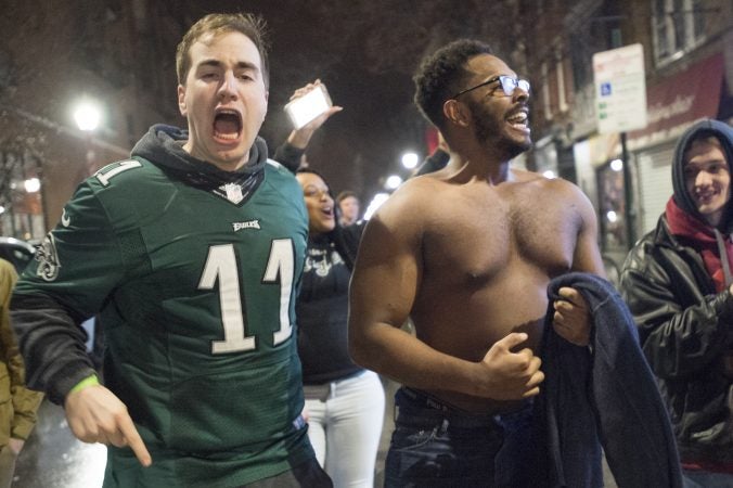 Eagles fans with and without jerseys parade along South St.