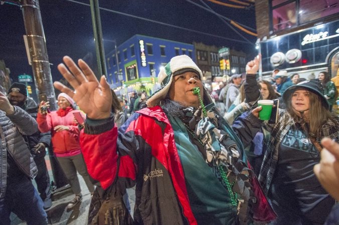 A celebrant blows a whistle as the crowd of Eagles fans walk towards Broad St.