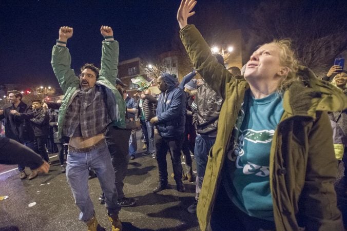 Fans cheer the Eagles at Broad and Kater Streets.