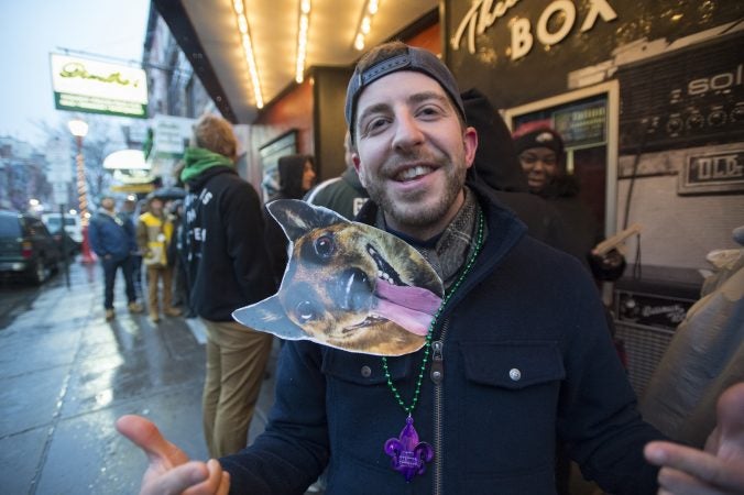 Daniel Peckler wares his underdog sign tucked into his jacket as he waits for the opening of the TLA tailgate party.