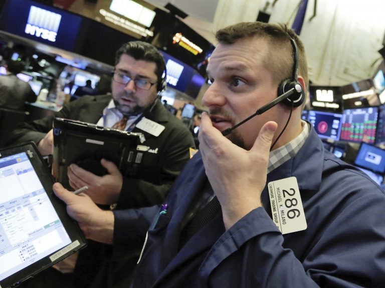 Trader Michael Milano (right) on the floor of the New York Stock Exchange on Thursday, a day when all the major U.S. stock indexes saw sharp drops.