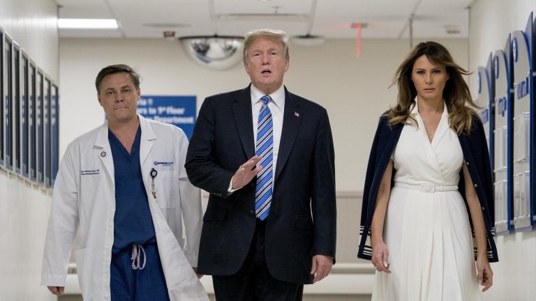 President Trump, accompanied by first lady Melania Trump, right, and Dr. Igor Nichiporenko, speaks to reporters while visiting medical staff at Broward Health North in Pompano Beach, Fla., on Friday.