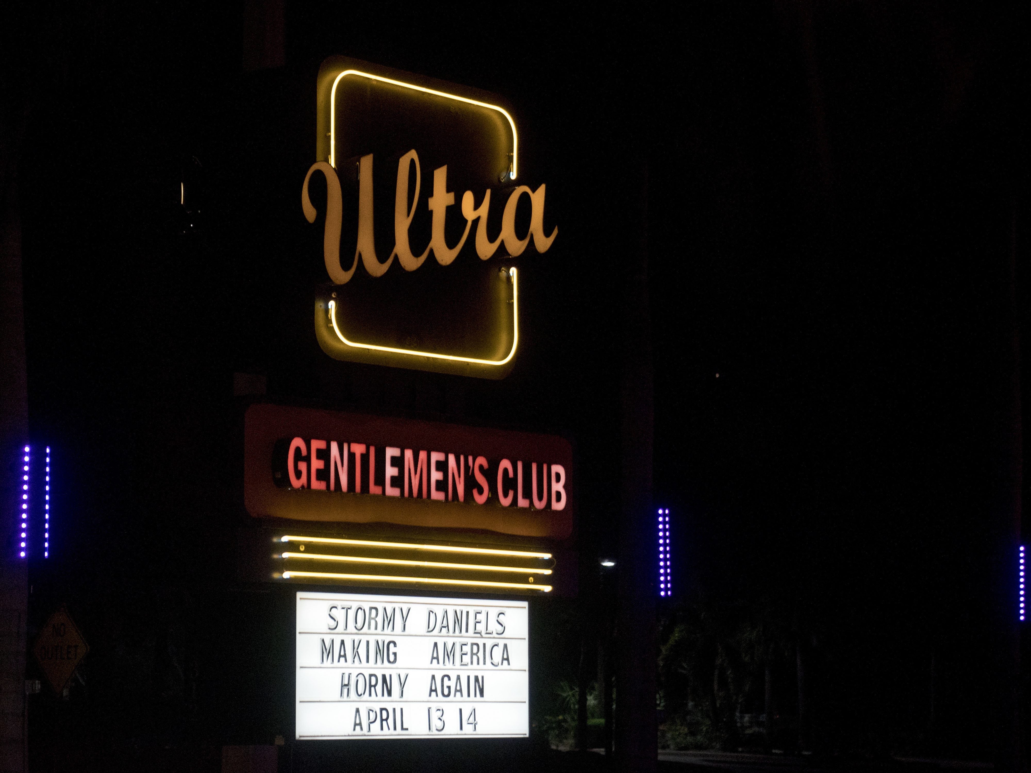 A sign for a Gentlemen's Club across the street from Trump International Golf Club that reads "Stormy Daniels Making America Horny Again" was seen from President Trump's motorcade.