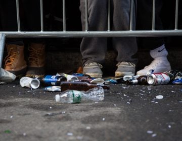 A close-up of trash on the sidewalk.