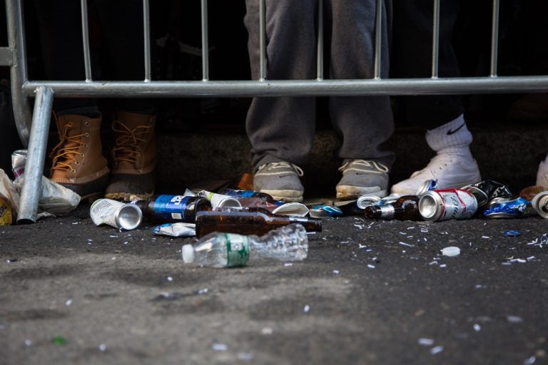 Beer cans and water bottles are shown on the ground.