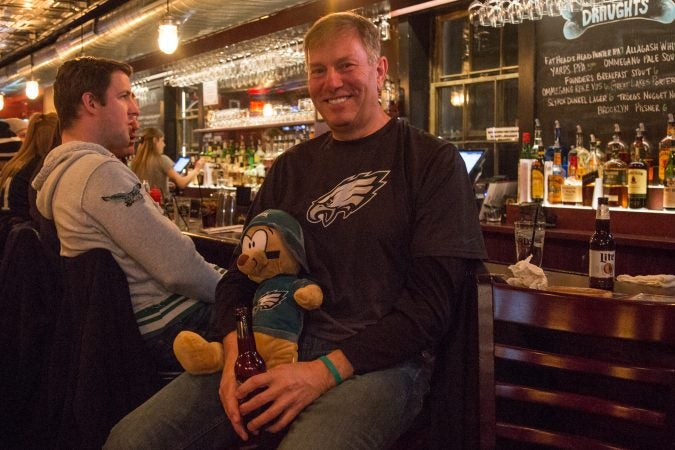 Bob Lamia, of Wayne, holds friend Jill's lucky bear Dougie before the start of the Super Bowl in Philadelphia February 4th 2018.