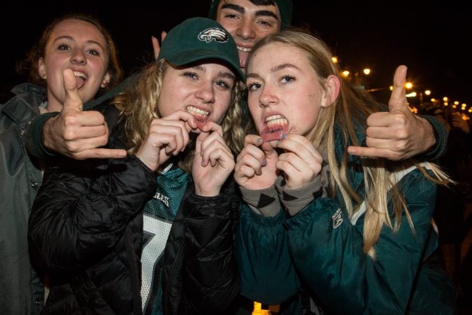 Fans show off their Eagles lip tattoos after the Eagles win the Super Bowl.