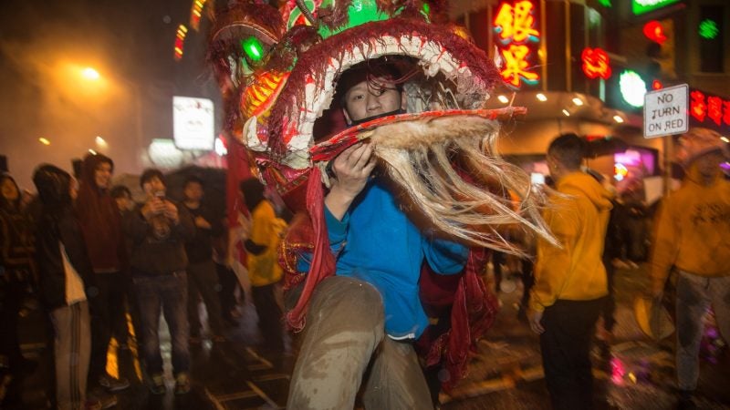 A member of the Philly Suns does a lion dance through the streets of Chinatown in celebration of the Chinese New Year on February 15, 2018. (Emily Cohen for WHYY)