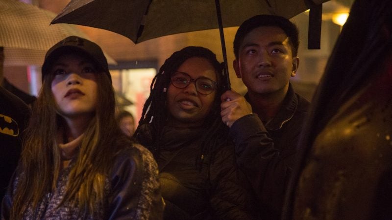 Revelers watch as very bright and very loud firecrackers are lit to celebrate the Chinese New Year in Phildelphia's Chinatown on February 15th 2018. (Emily Cohen for WHYY)