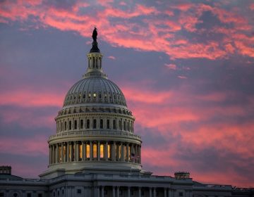 FILE - In this Thursday, Nov. 30, 2017, file photo, the sky over The Capitol is lit up at dawn  (AP Photo/J. Scott Applewhite, File)