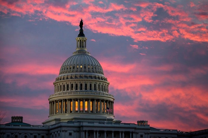FILE - In this Thursday, Nov. 30, 2017, file photo, the sky over The Capitol is lit up at dawn  (AP Photo/J. Scott Applewhite, File)
