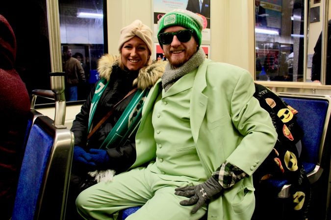 Sean Mundy, 32, of East Kensington, and his wife, Meghan Haley, 28, head to the Eagles Super Bowl parade in style on the Market Frankford line.