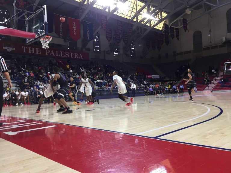 Imhotep Charter (white) and MLK High School (black) playing the city public league title game at the Palestra, February 25, 2018. (Avi Wolfman-Arent/WHYY)