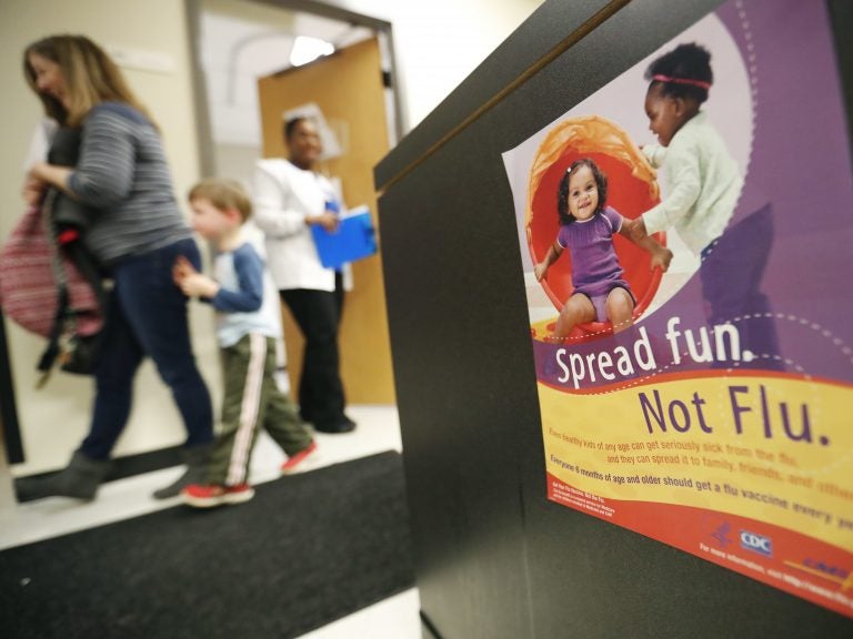 People 6 months and older should get vaccinated against the flu, says this government poster on display  in a health center in Decatur, Ga