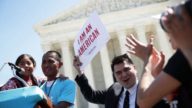 Six-year-old Sophie Cruz speaks during a rally in front of the Supreme Court next to her father Raul Cruz and supporter Jose Antonio Vargas in 2016.