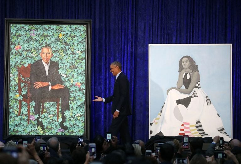 Former U.S. President Barack Obama stands with his and former first lady Michelle Obama's newly unveiled portrait during a ceremony at the Smithsonian's National Portrait Gallery (Mark Wilson/Getty Images)