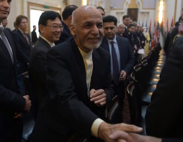 Afghan President Ashraf Ghani shakes hands with a foreign delegate at the Kabul Process conference in the country's capital Wednesday. During the conference, Ghani called on the Taliban to participate in peace talks with the Afghan government. (Shah Marai/AFP/Getty Images)
