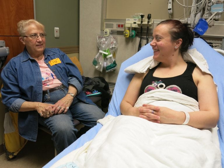 Ashley Copeland (right) talks to her mom Sue Iverson in the Swedish Medical Center emergency department, near Denver. Copeland got a nerve-blocking anesthetic instead of opioids to ease her severe headache. At discharge she was advised to use over-the-counter painkillers, if necessary.
(John Daley/CPR News)
