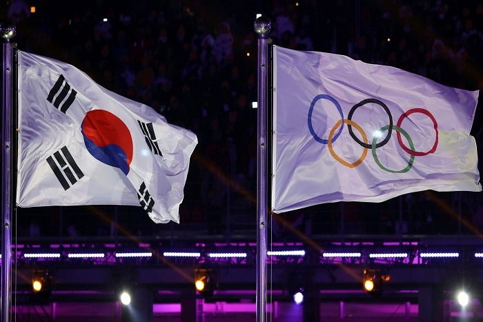 The South Korea and Olympic flag are seen during the opening ceremony of the 2018 Winter Olympics in Pyeongchang, South Korea, Friday, Feb. 9, 2018. (AP Photo/Michael Sohn)