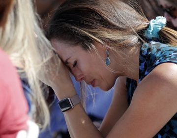 A woman cries as she bows her head in prayer during a vigil at the Parkland Baptist Church, for the victims of the Wednesday shooting at Marjory Stoneman Douglas High School, in Parkland, Fla., Thursday, Feb. 15, 2018. Nikolas Cruz, a former student, was charged with 17 counts of premeditated murder on Thursday. (AP Photo/Gerald Herbert)