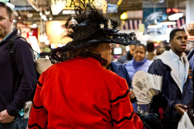 Historical reenactor Nonnie Cyd greets shoppers at Reading Terminal Market's 125th Anniversary Celebration. (Kimberly Paynter/WHYY)