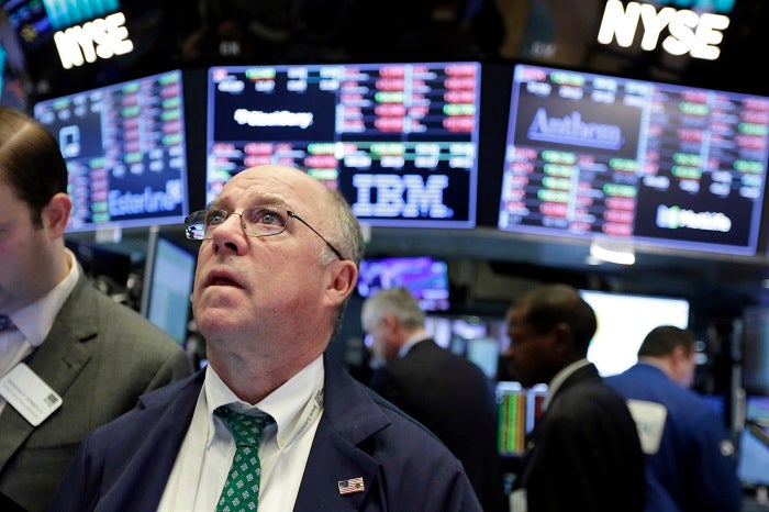 Trader Frederick Reimer works on the floor of the New York Stock Exchange, Tuesday, Feb. 6, 2018. The Dow Jones industrial average fell as much as 500 points in early trading, bringing the index down 10 percent from the record high it reached on Jan. 26. The DJIA quickly recovered much of that loss. (AP Photo/Richard Drew)